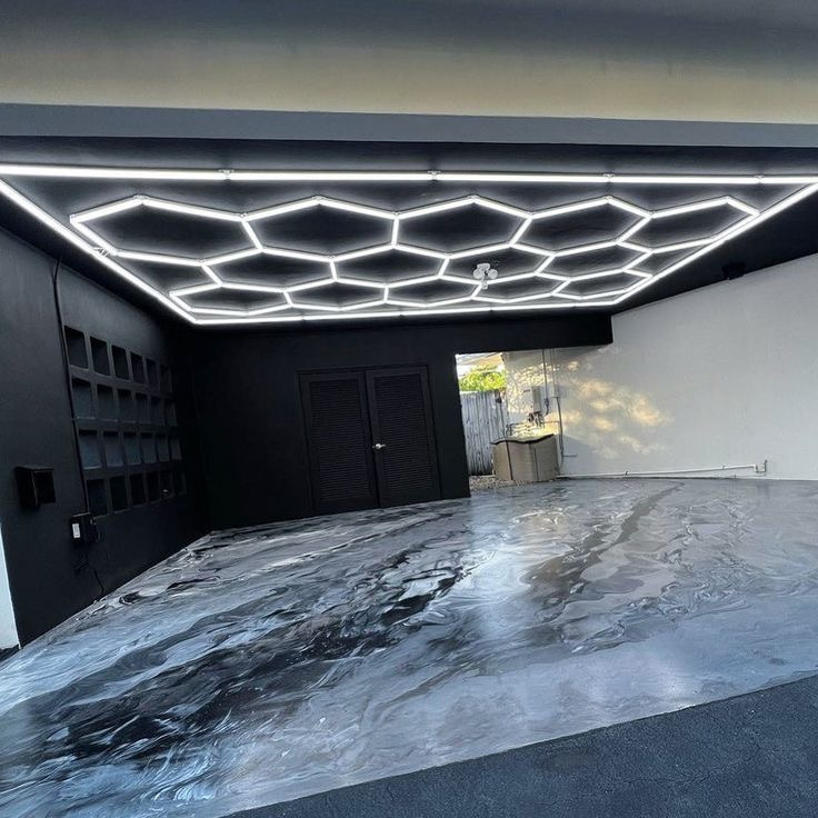 Gray and white marble metallic garage floor with hex lights in a new Washington Utah home